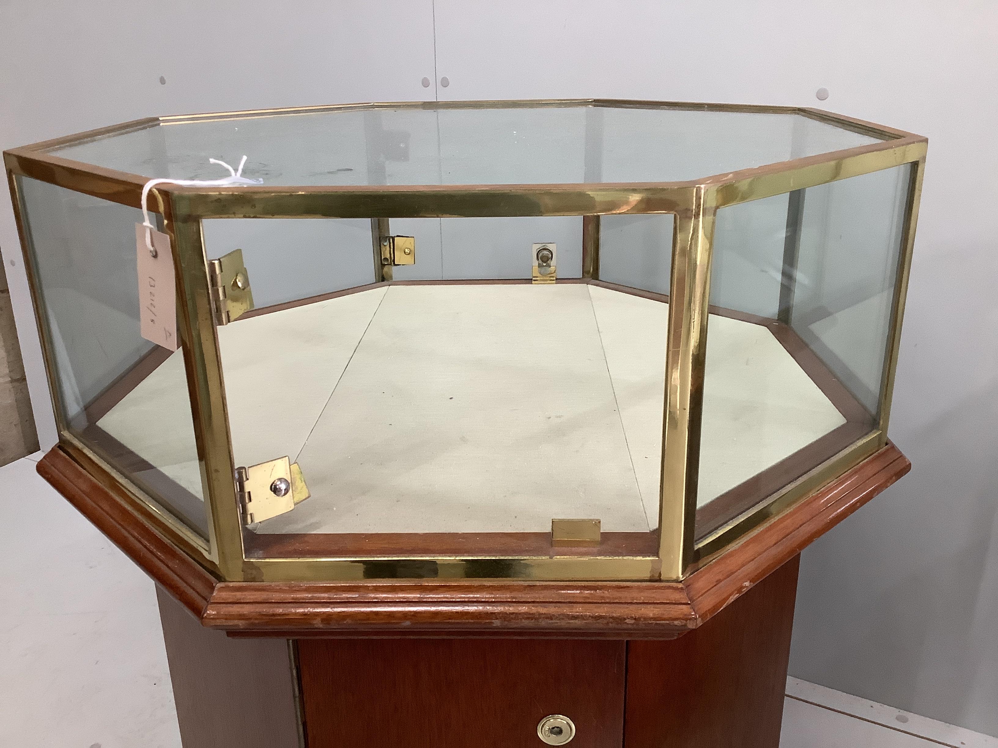 A pair of octagonal brass mounted display cases, width 69cm, height 90cm